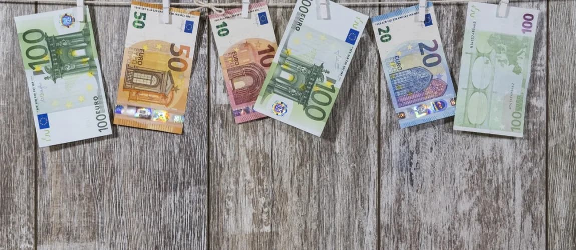 Verschiedene Euroscheine liegen auf einem hölzernen Untergrund.