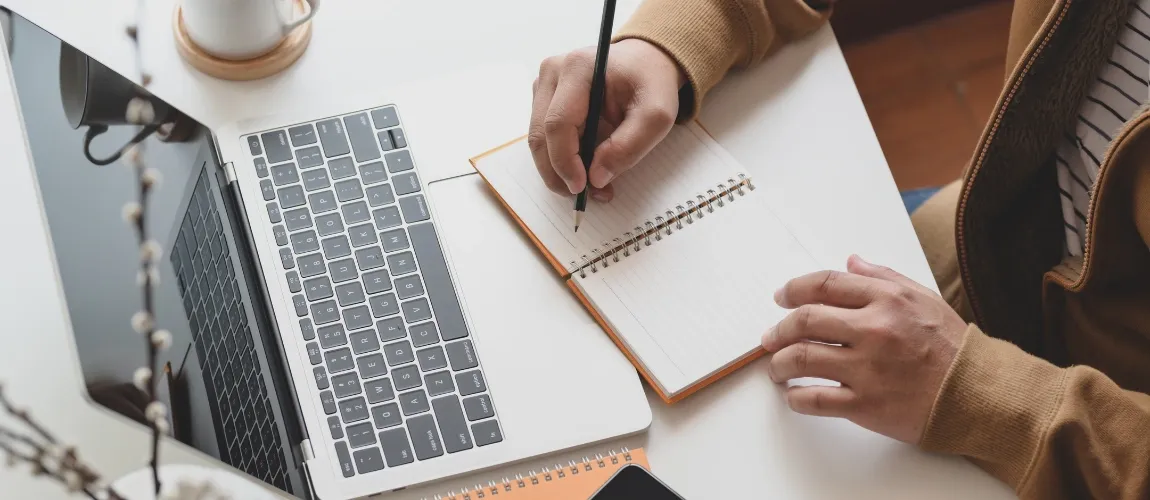 Pflegekraft stellt Pflegegrad-Antrag für Pflegebedürftige - Frau sitzt vor einem Laptop und schreibt.